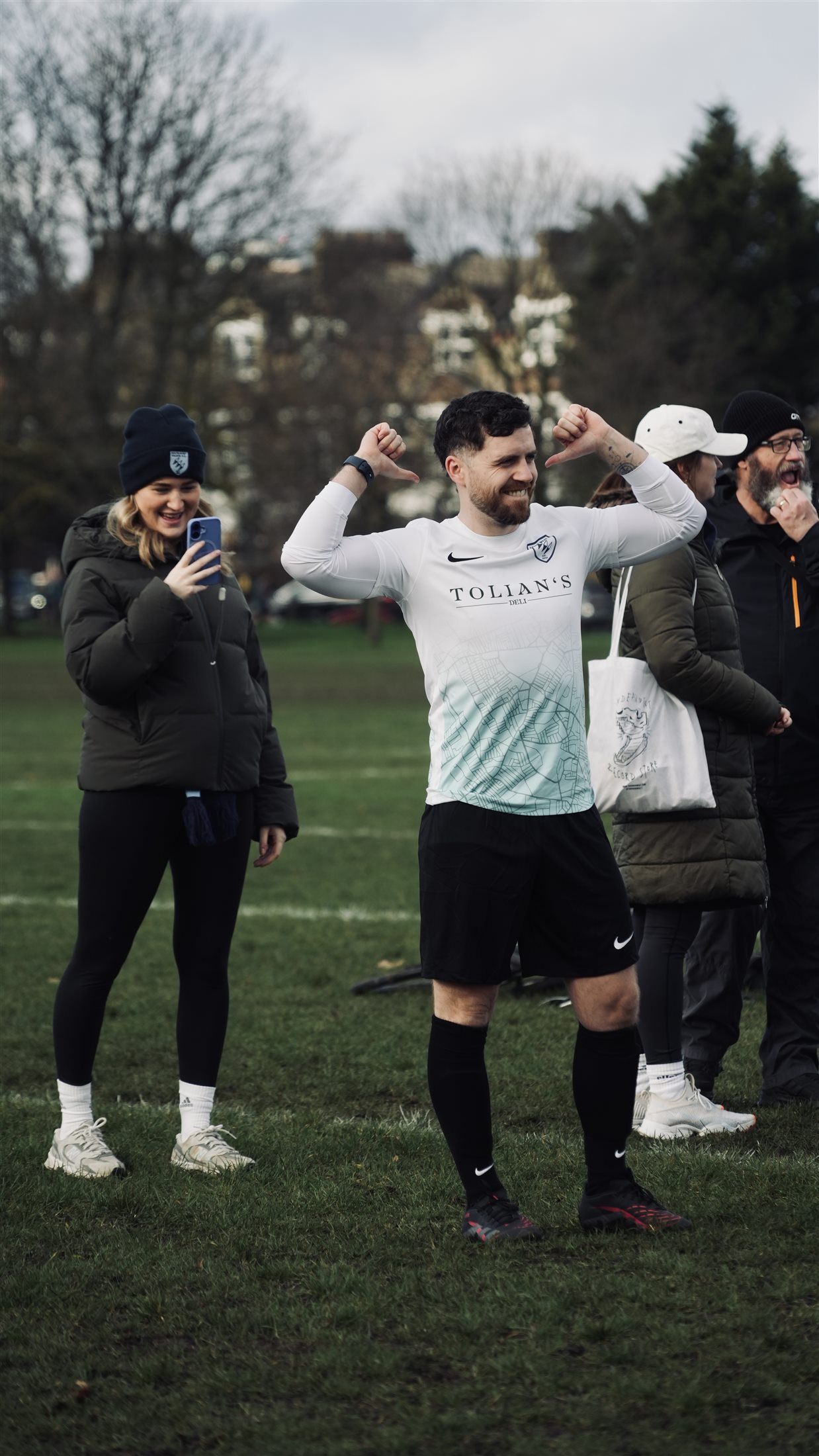 A WAGs player celebrates in front of supporters on the touchline