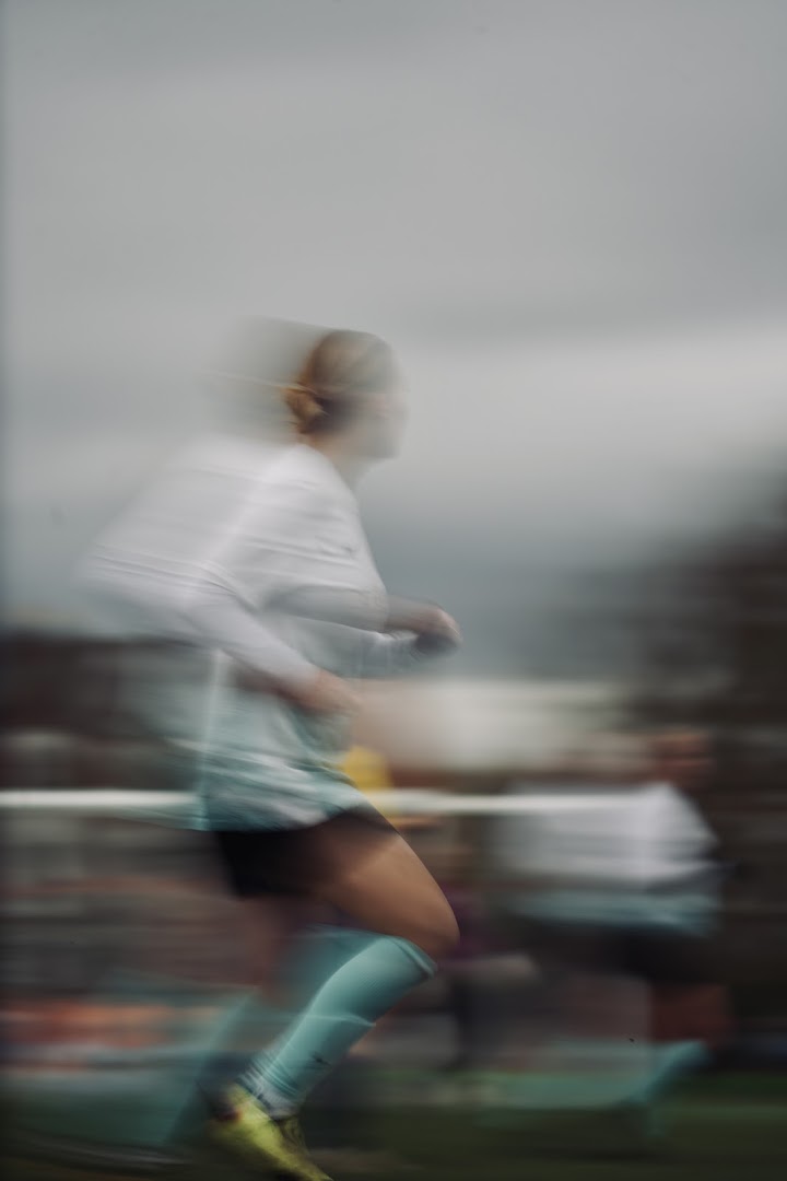 A Saints player in the map-print home shirt captured in motion during a match