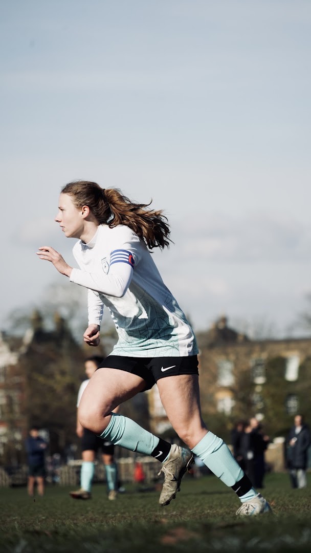 A Saints player sprints forward during a match on Clapham Common