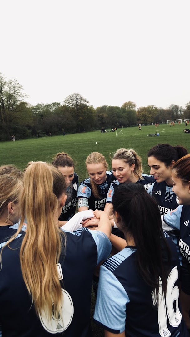 South West Saints players gather in a close team huddle