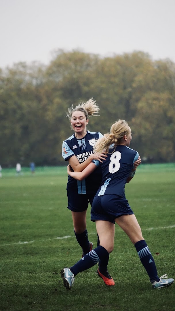 Two Saints players celebrate together on the pitch