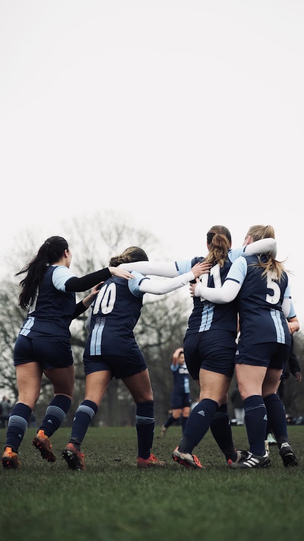 Saints players walk together with their arms around one another on the pitch